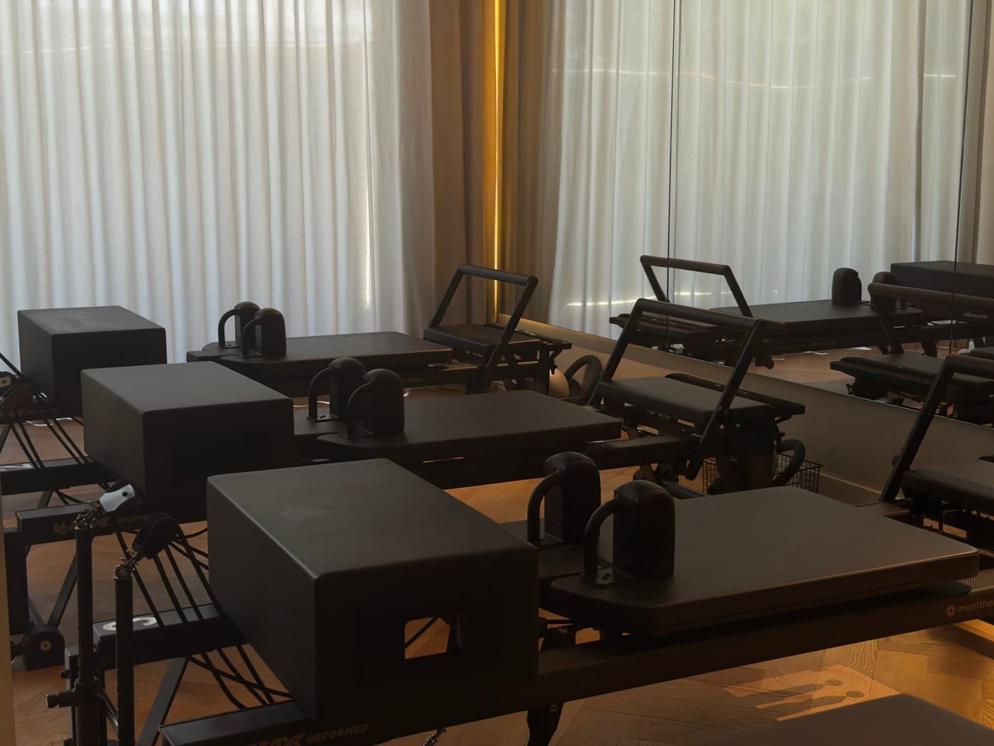 Reformer studio with several machines before class